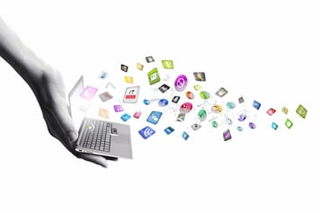 Close up of hand with laptop and media icons-1