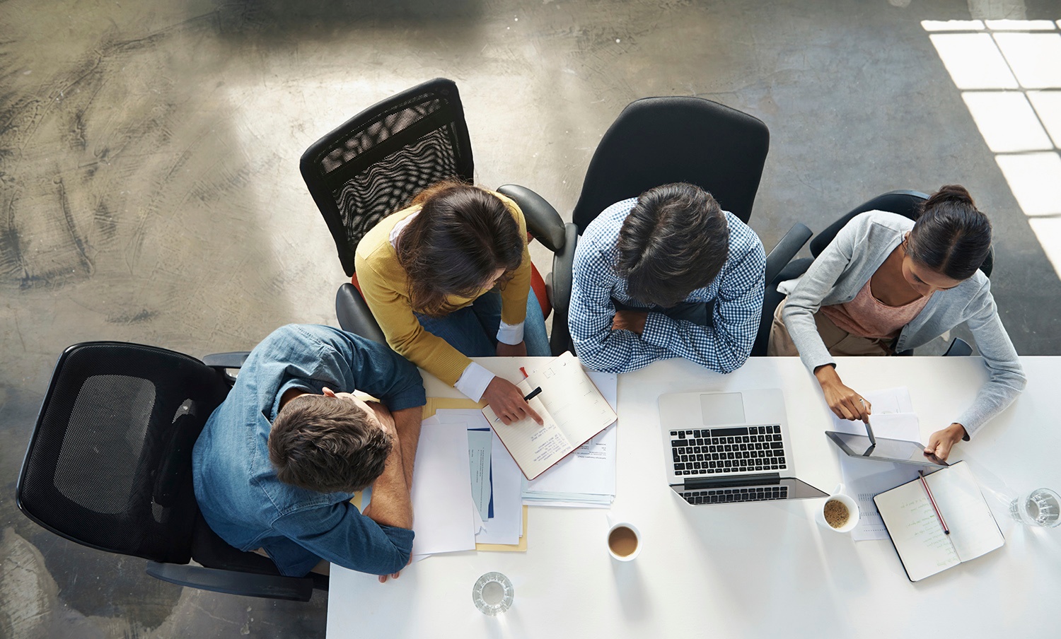 Marketing team sat around a desk discussing inbound marketing