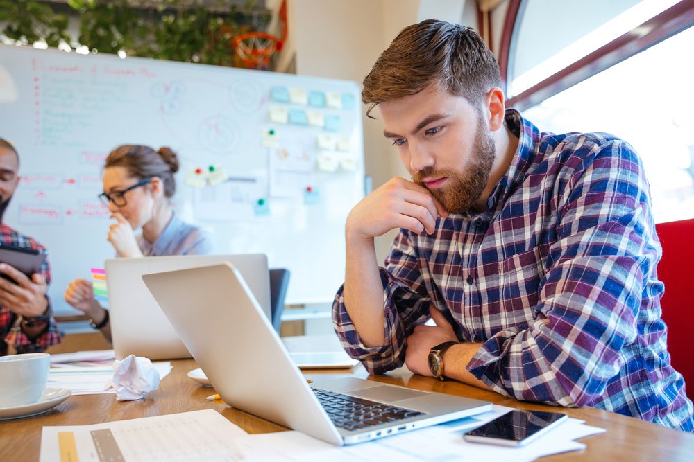 Creating content that connects - man sitting looking at laptop