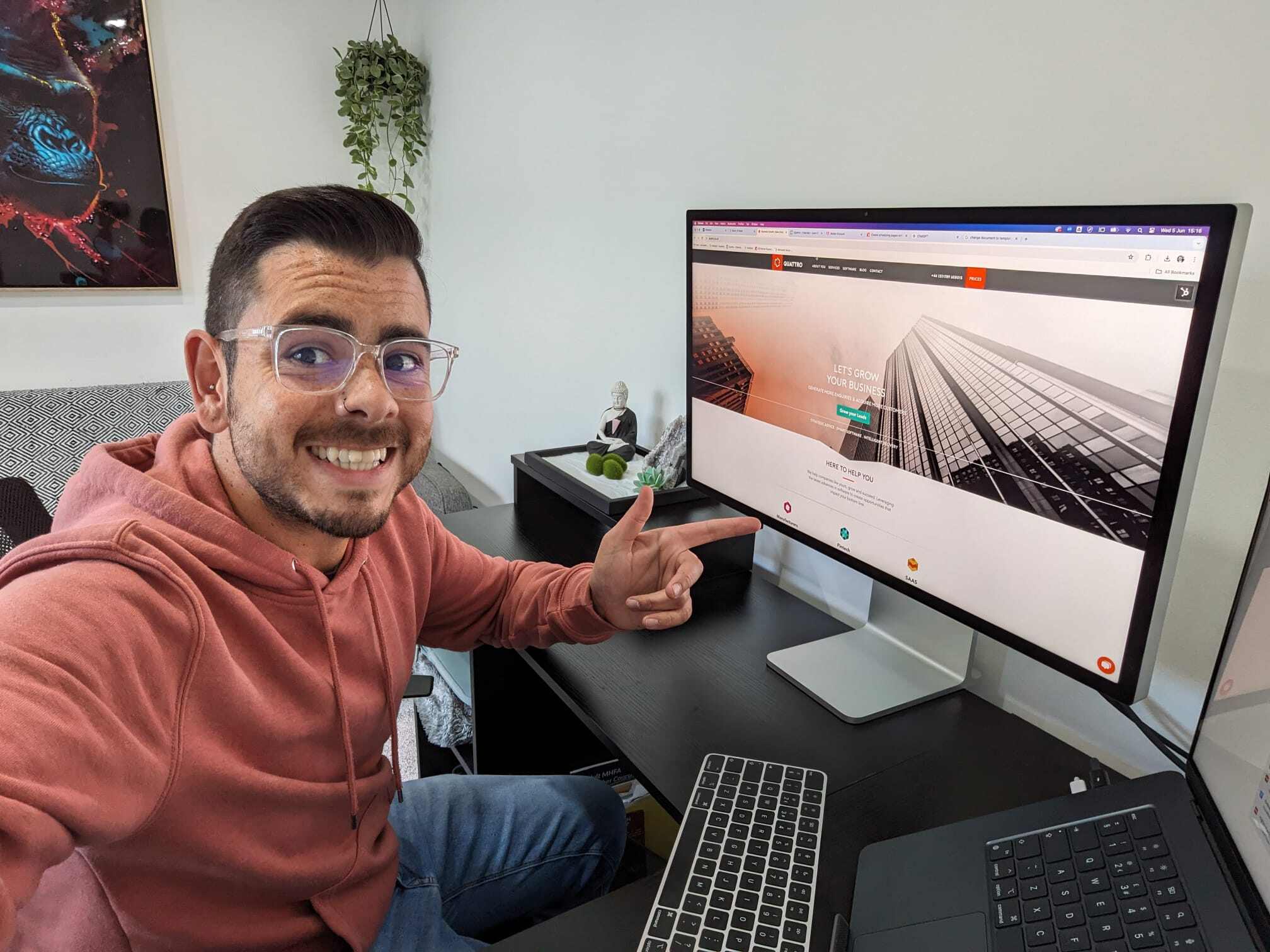 HubSpot for Recruiters - blog author sat at desk smiling, pointing at home page on screen of Quattro his new employer.